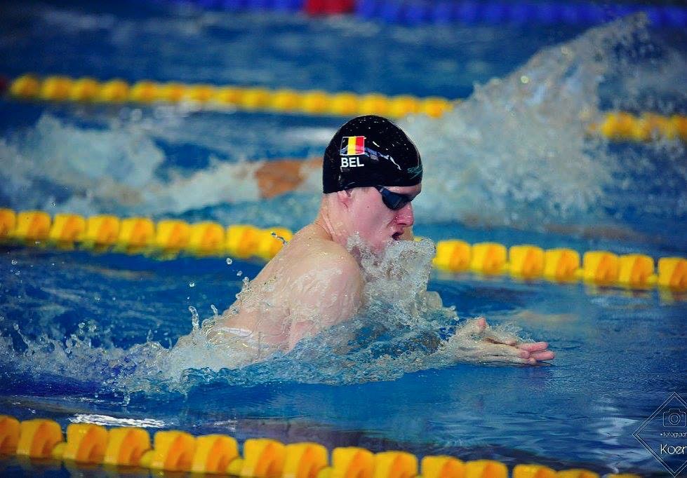 Swimmer competing in a breaststroke race
